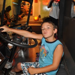 A boy is driving a vehicle.