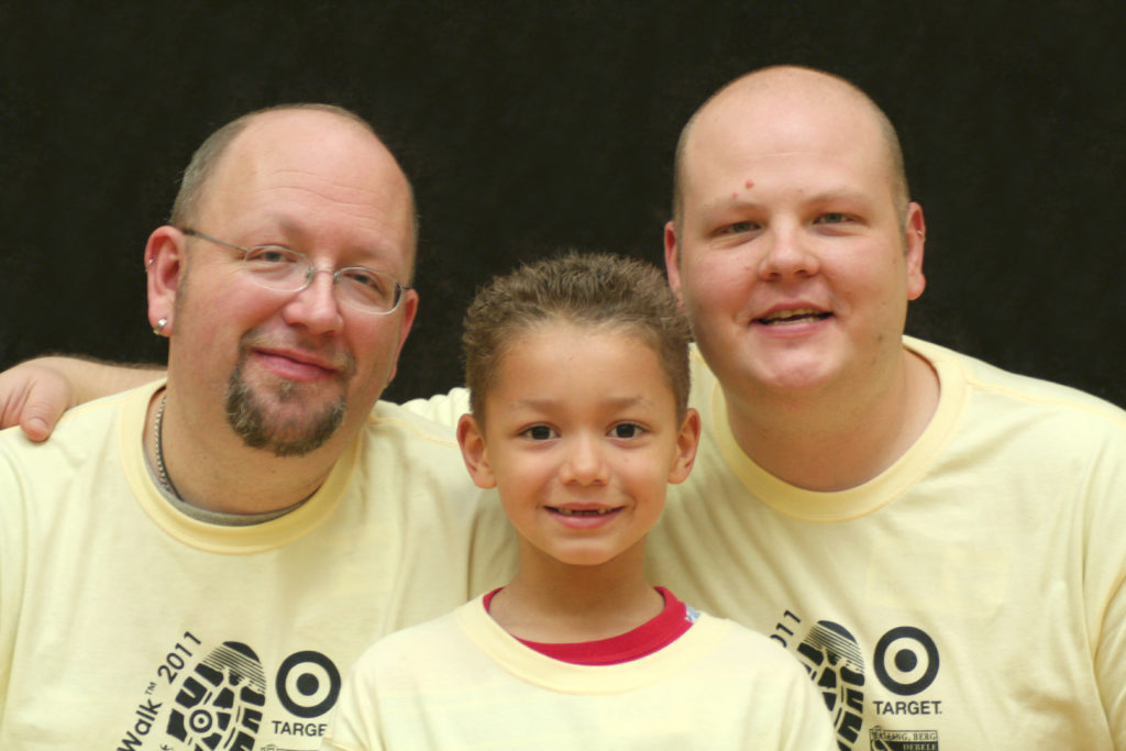 Two dads with young child
