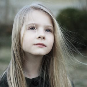 Young girl standing outside and thinking