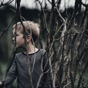 Boy by trees