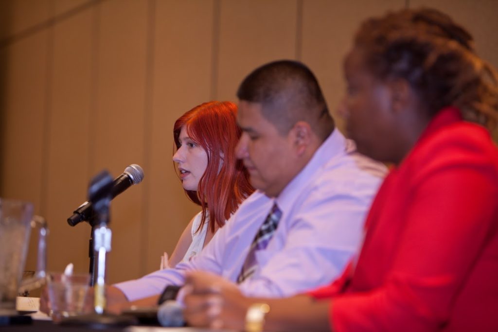 A panel of three people.