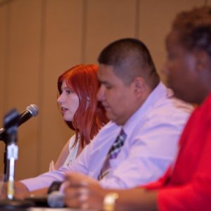 A panel of three people.