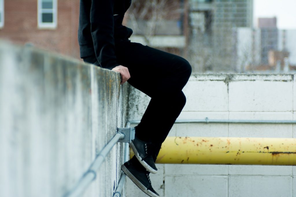 Person sitting on a wall