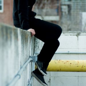 Person sitting on a wall