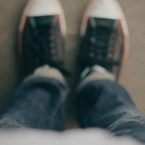 Child looking down at tennis shoes