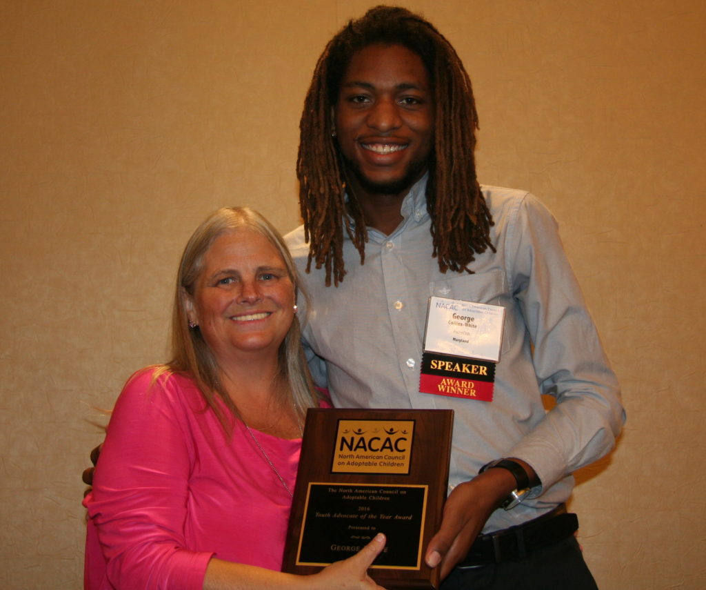 Board chair presenting award to a young man